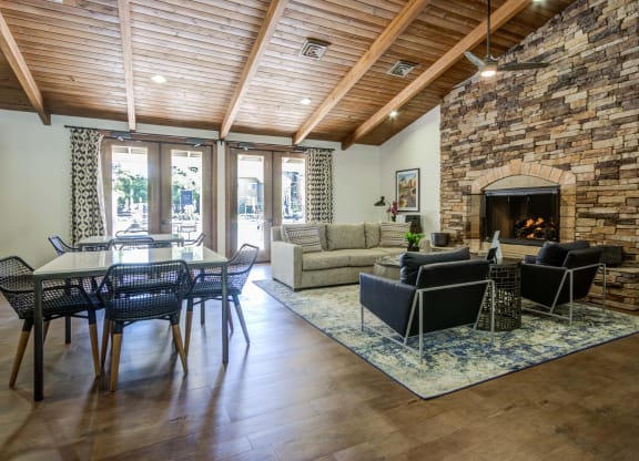 a living room with a fireplace and a dining table