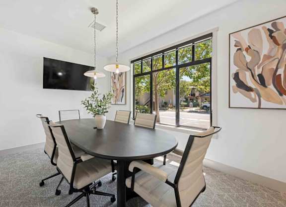A modern dining room with a round table and chairs.
