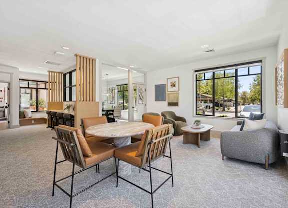 A modern dining room with a large table and chairs.