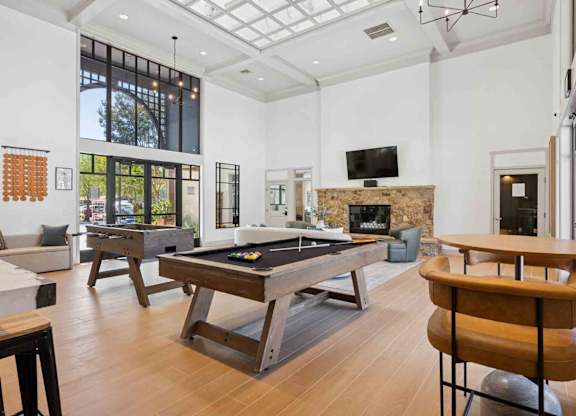 A room with a pool table and a fireplace.