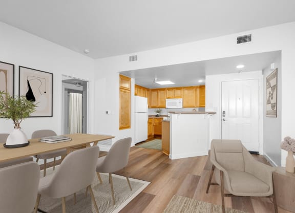 a living room and kitchen with a dining table and chairs