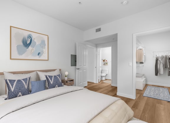 2-Bedroom Apartments in Goleta, CA - Willow Springs - Bedroom with Wood-Style Flooring, Bed, Nightstand with Lamp, Large Walk-In Closet, and Private Bathroom
