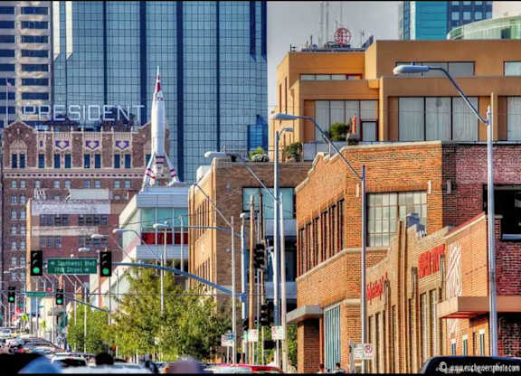 A city street with a building that says President in the background.
