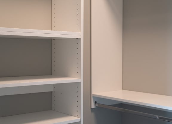 Empty white shelves with holes for hanging items.
