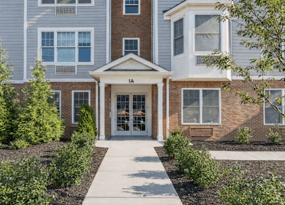 A building with a front entrance and a walkway leading to it.