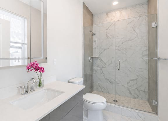 A white toilet sits next to a sink in a bathroom.