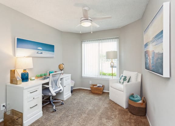 an office with a desk and a chair and a window at The Villages of Banyan Grove, Florida, 33436