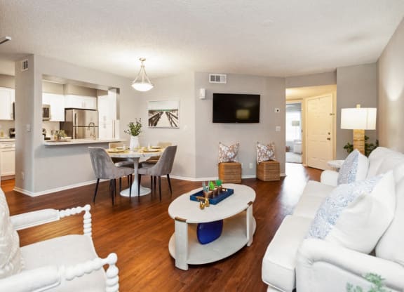 a living room and dining room with a couch and a table at The Villages of Banyan Grove, Boynton Beach, 33436