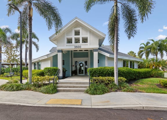 the front of a house with palm trees at The Villages of Banyan Grove, Florida, 33436