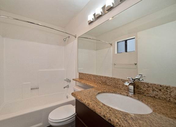 a bathroom with a bathtub and a sink at Croft Plaza Apartments, West Hollywood