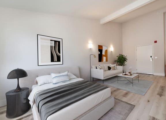 a bedroom with a bed and a couch and a living room  at Track 281 Apartments, Sacramento, CA