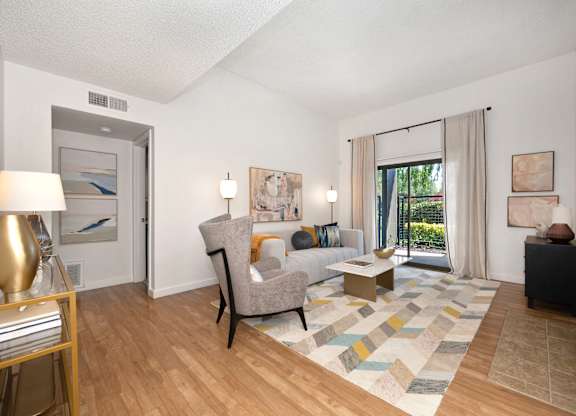 a living room with hardwood floors and a sliding glass door at Fountains of Fair Oaks, Fair Oaks, CA 95628