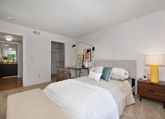 a bedroom with two beds and a desk with a lamp at Fountains of Fair Oaks, Fair Oaks, CA
