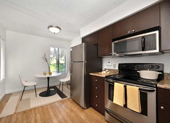a kitchen and dining area in a 555 waverly unit at Fountains of Fair Oaks, Fair Oaks, CA
