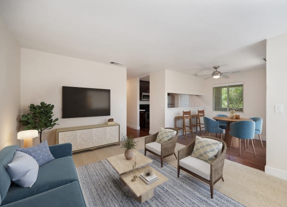 a living room and dining room with a couch and chairs and a television at Folsom Ranch, Folsom, California