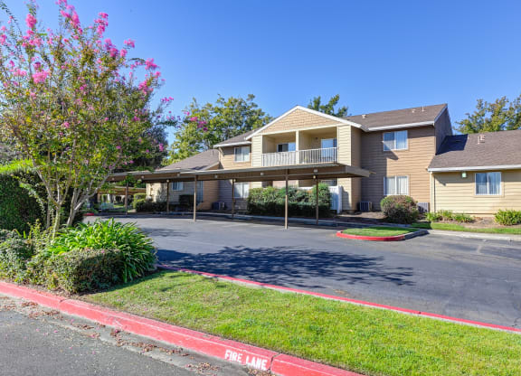 Hastings Park parking lot with covered carport parking spaces and mature landscaping 