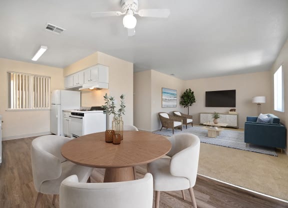 a living room with a dining room table and chairs