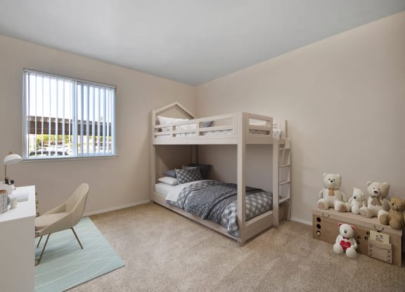 a bedroom with a bunk bed and a desk with teddy bears