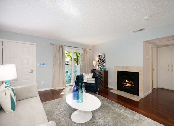Spacious Living Room with Hardwood Flooring and Stylish Interior Showing Natural Light at Hidden Oaks Apartments, Citrus Heights, CA