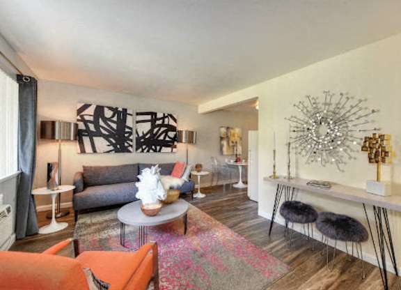 The Douglas floor plan living Room with Hardwood Inspired Floors, Orange Chairs and Window  at Olympus Park Apartments, California, 95661