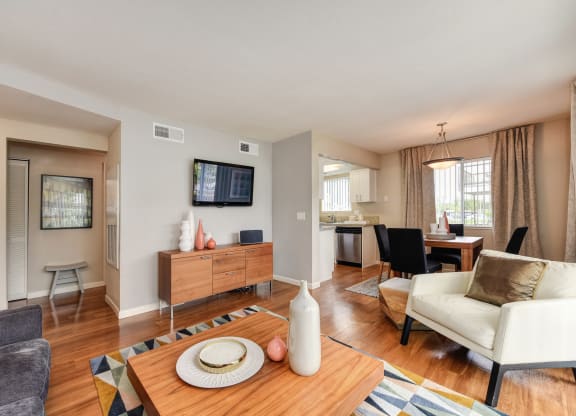 Living Room with Television with Wood Inspired Floor, White Sofa at Addison Ranch Apartments, Petaluma