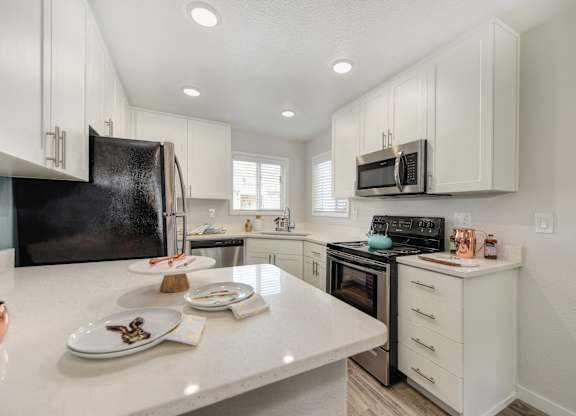 Kitchen with White Countertop at The Legacy Apartments, Antelope, California