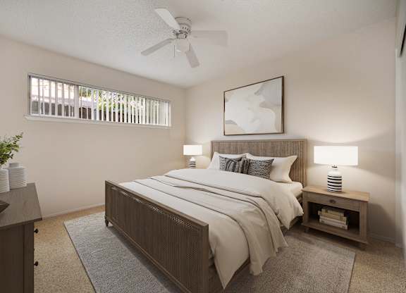 A bedroom with a bed, nightstand, and a ceiling fan.