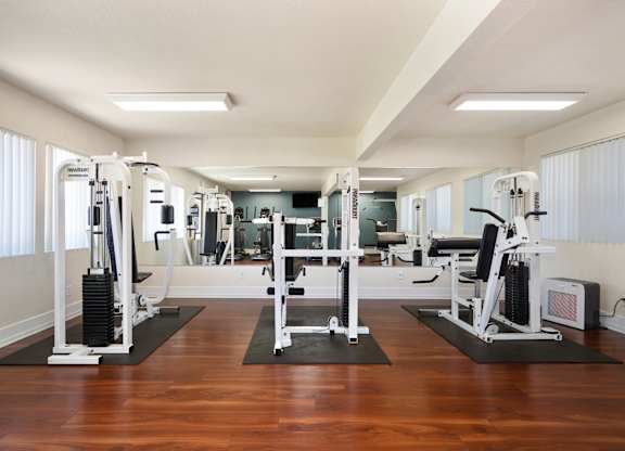 a workout room with a variety of exercise equipment