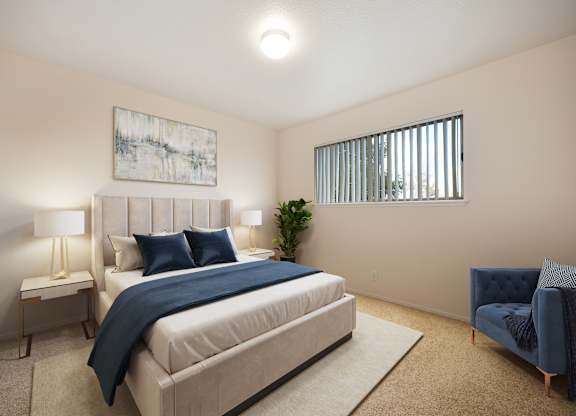 A bedroom with a large bed and a blue chair.