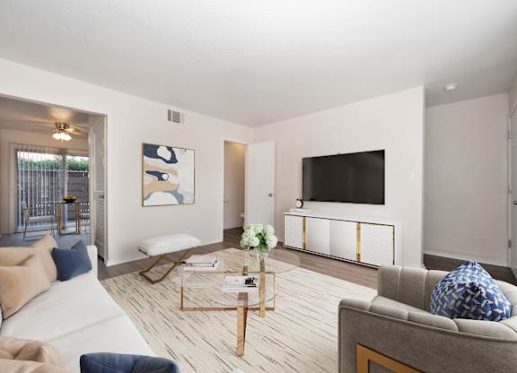 A living room with a grey couch and a coffee table.