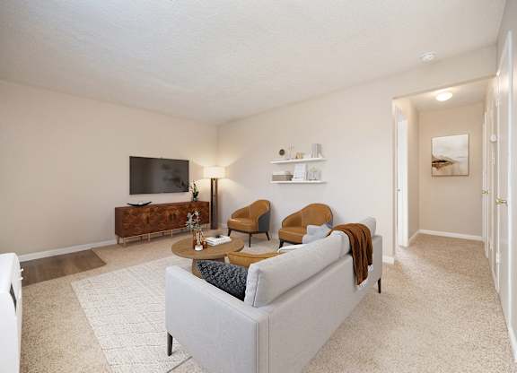 A living room with a white couch and a television.