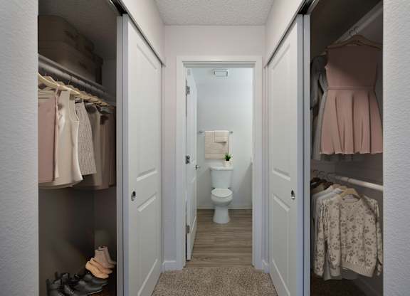 A small bathroom with a toilet and a plant in the middle.