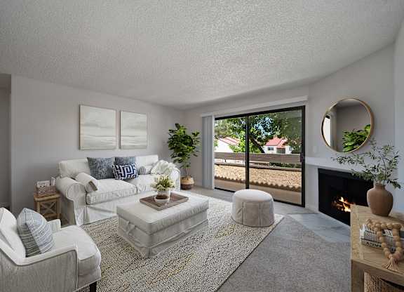 A living room with a fireplace and a view of a house through the window.