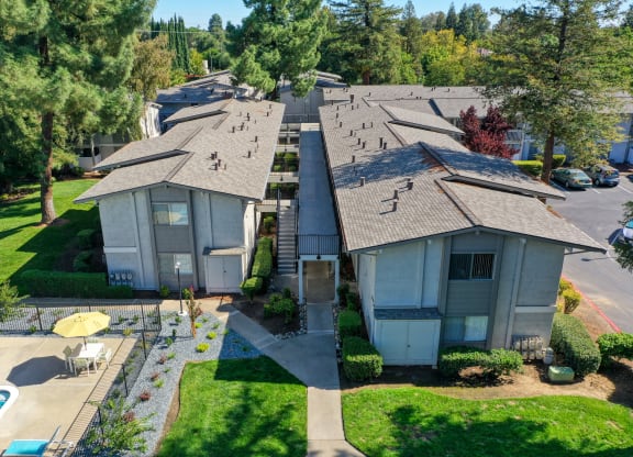 Ariel shot above the community overlooking the buildings, walk paths and community swimming pool. at Renaissance Park Apartments, California, 95618