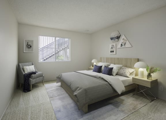 a bedroom with a bed and a chair and a window at Renaissance Park Apartments, California
