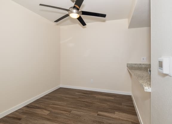 One Bedroom Dining Room with a ceiling fan and bar style counter top at Rocklin Manor  Apartments, California