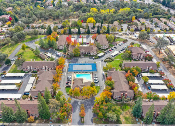 Drone shot of the entire Rocklin Manor community. Showing all buildings, Leasing office, pool, sports court and the mature landscaping at Rocklin Manor  Apartments, Rocklin  , CA