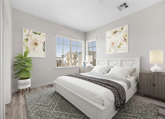 a bedroom with a bed and two windows