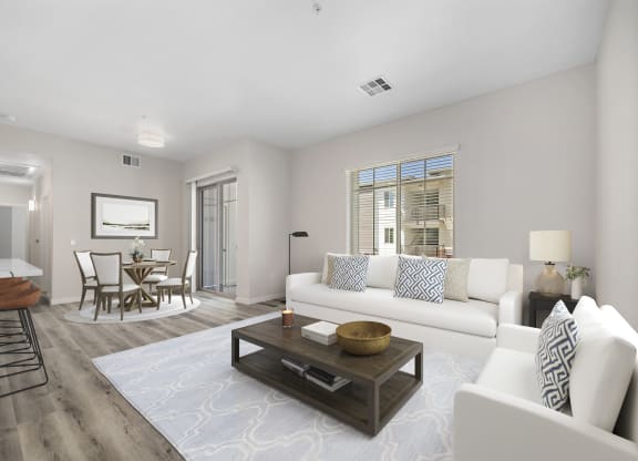 a living room with white couches and a coffee table