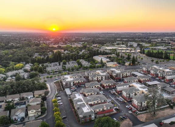 an aerial view of Sierra Gateway Apartments at sunset with Sierra College in the distance