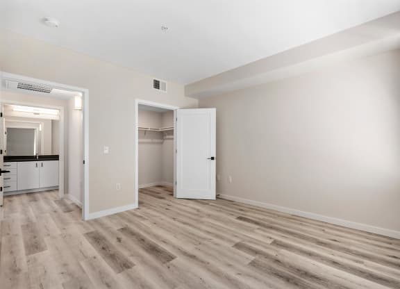 an empty living room with white walls and wood flooring
