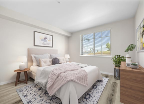a bedroom with a large bed and a large window