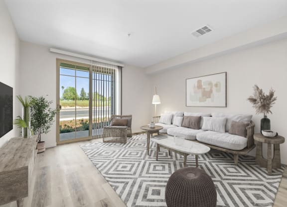 a living room with a white couch and a large rug