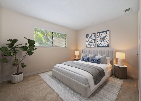 a bedroom with a white bed and a potted plant at Silverstone Apartments, Davis