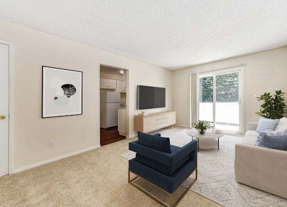 A living room with a blue sofa and a television.