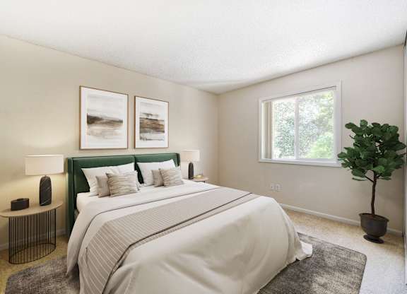 A bedroom with a large bed and a green headboard.