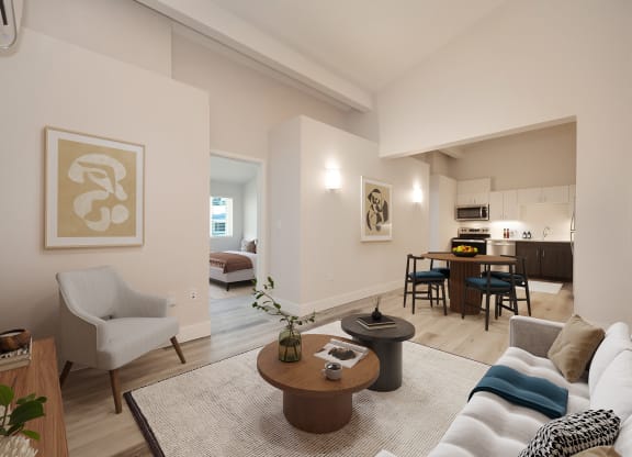a living room with a couch and a table and a kitchen in the background  at Track 281 Apartments, Sacramento, CA