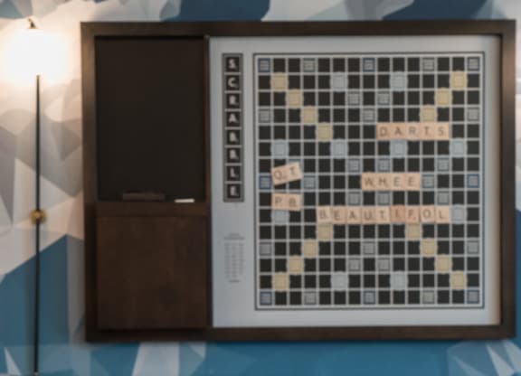 a chess board on a table in a room with a tv