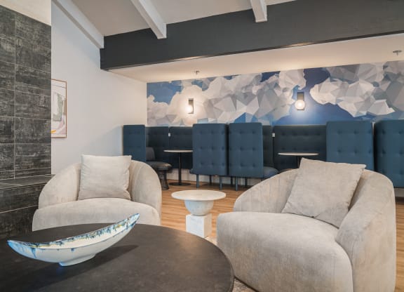 a living room with couches and chairs and a table with a bowl