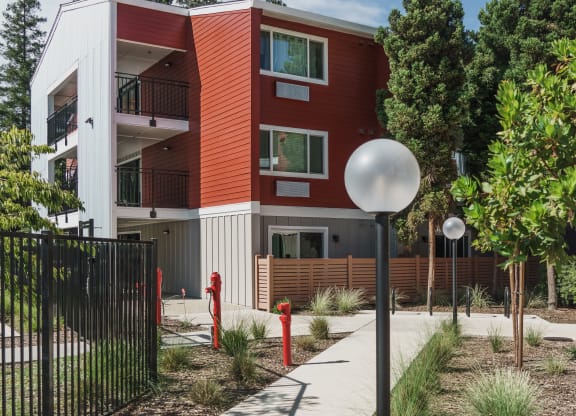 a red and white building with a sidewalk in front of it